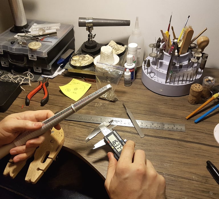 a person holding a ruler and measuring ruler