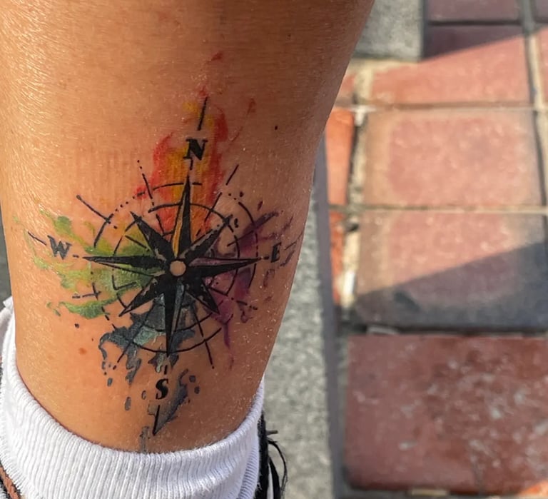 a picture of watercolor compass tattoo from a customer