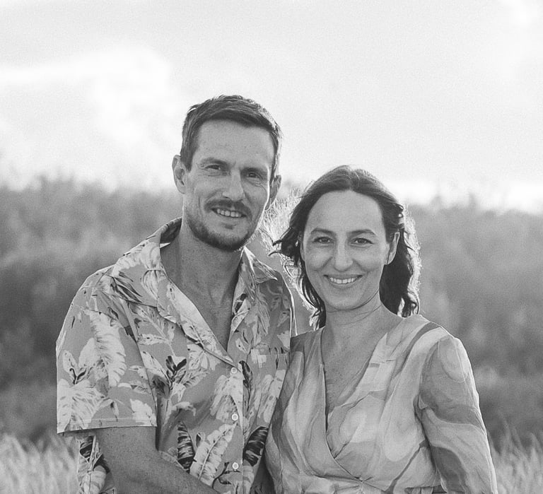 family business owners standing in front of dunes and bush