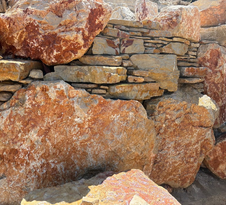 Limestone boulders & veneer stonework with hidden mortar—engineered strong yet appears fully natural