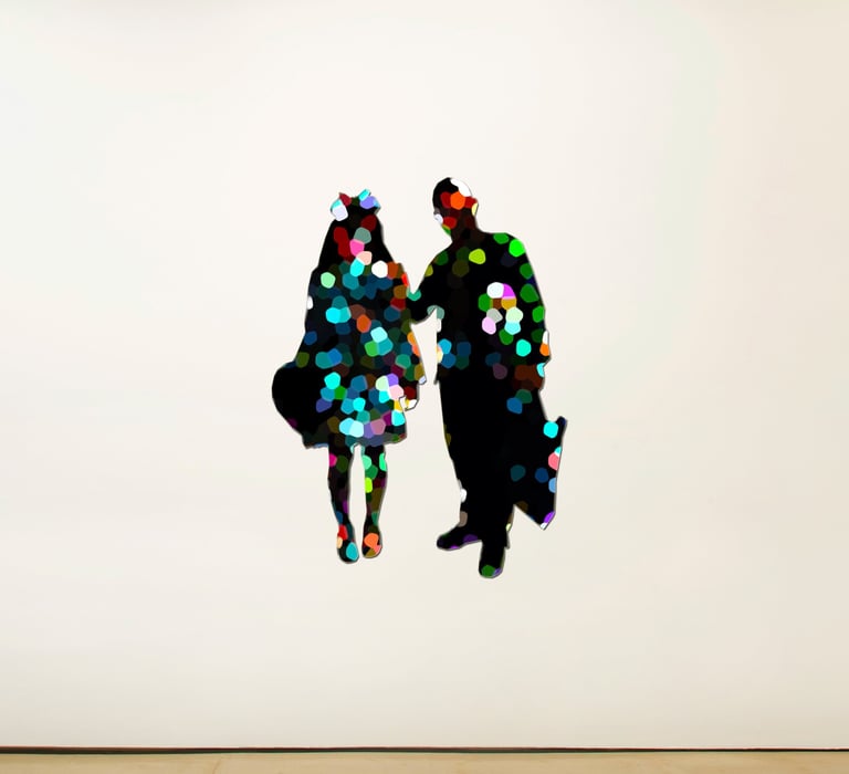 a couple of people standing in front of a white wall