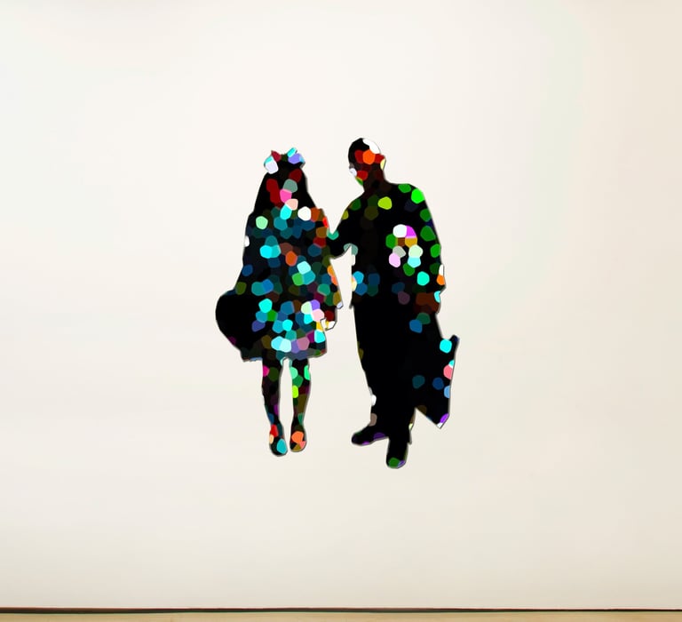 a couple of people standing in front of a white wall