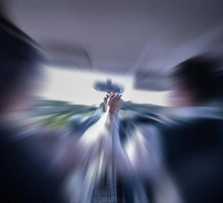 wedding couple holding hands in their car