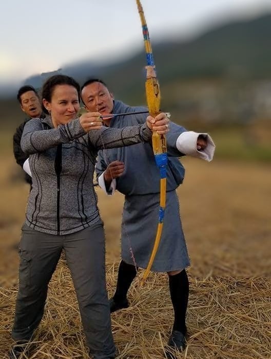 drukyul_delights_ceo_with_guest_experiencing_archery_session_in_punakha_bhutan