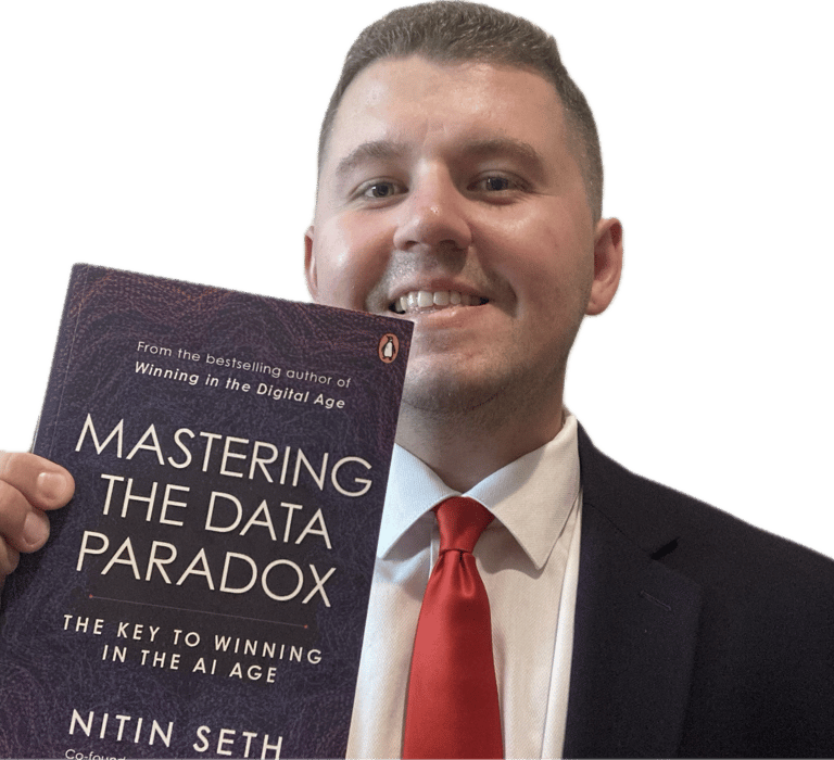 Jake Byford holding a book titled Mastering the Data Paradox by Nitin Seth