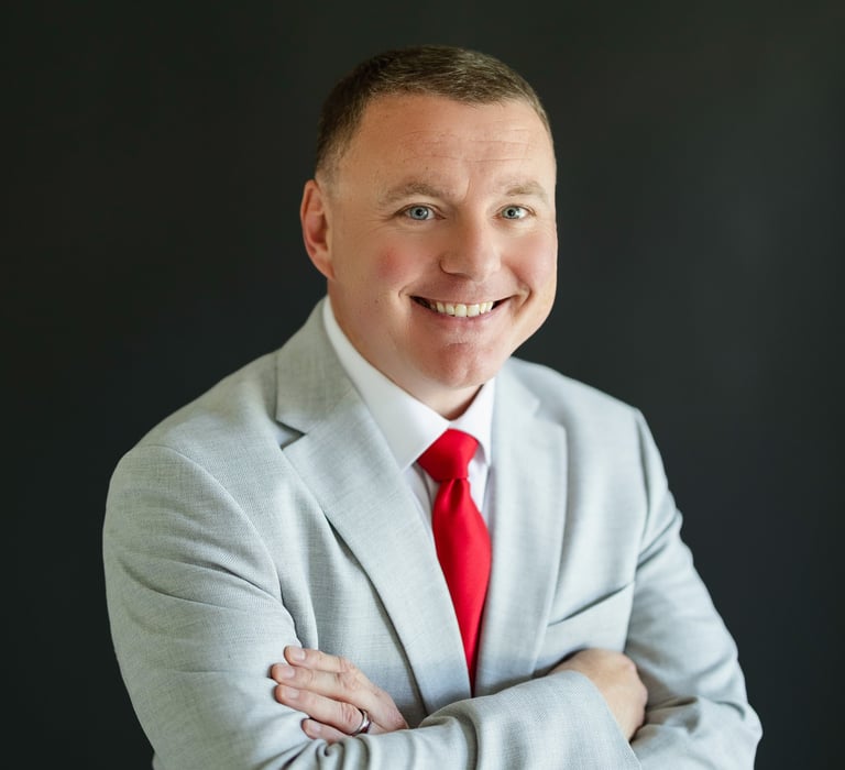 Shawn Kaeser in a suit and red tie