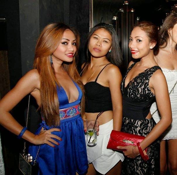 a group of women standing around a woman in a dress