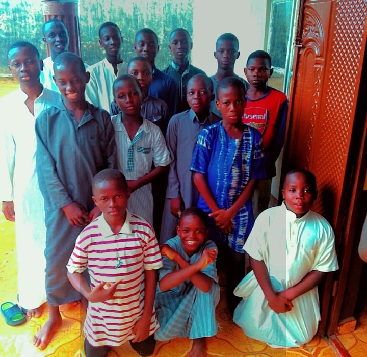 Inspirational image of diverse kids reading the Holy Quran together.