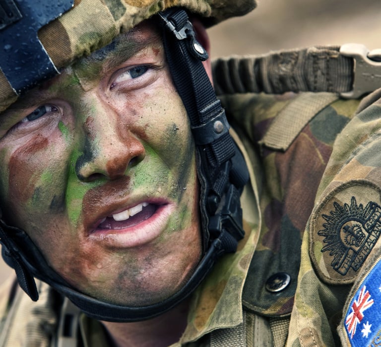 Close up of an Australian soldier in full camouflage uniform and face paint