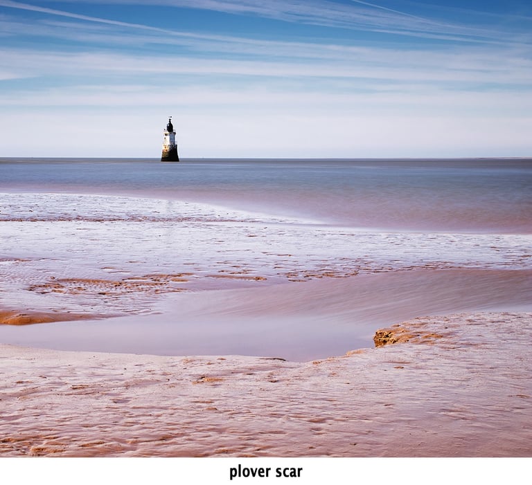 plover scar lighthouse in morecambe bay at cockerham sands
