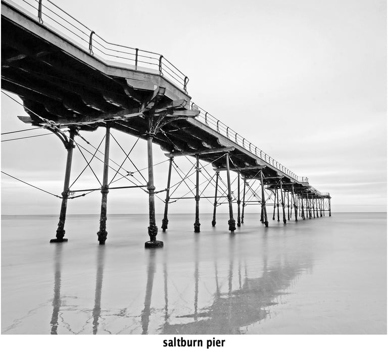 saltburn pier reflected in a still tide