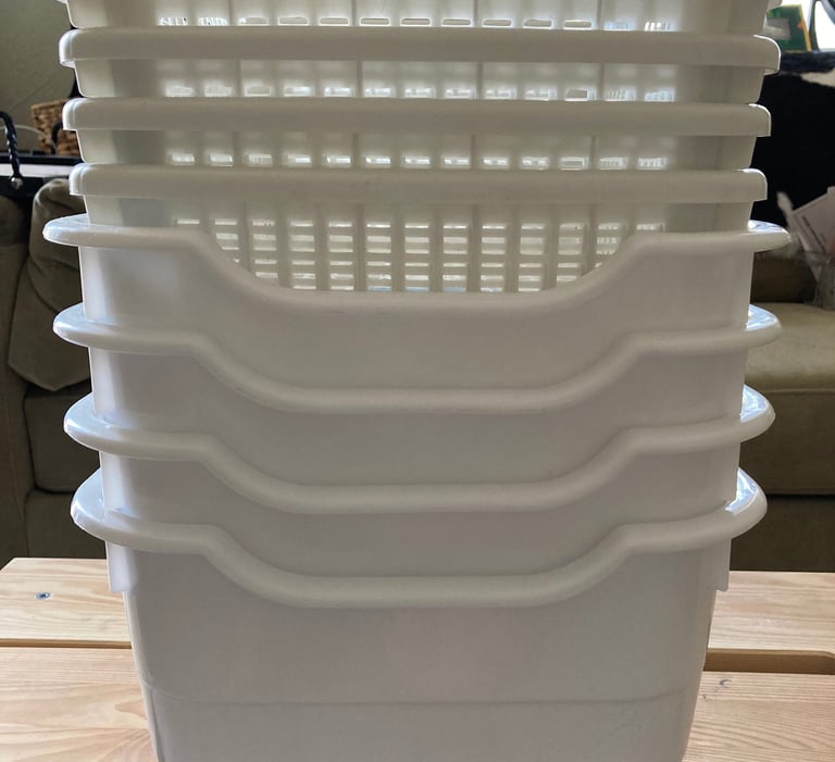 Plastic dishpans and baskets stacked up