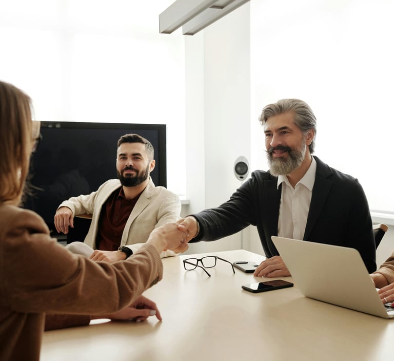 a man and woman shaking hands in a meeting room for mission