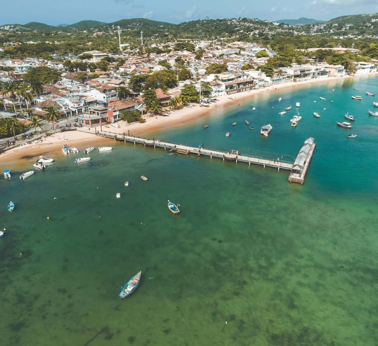 a pier with boats and a pier in the background in Buzios, Rio de janeiro, Brazil