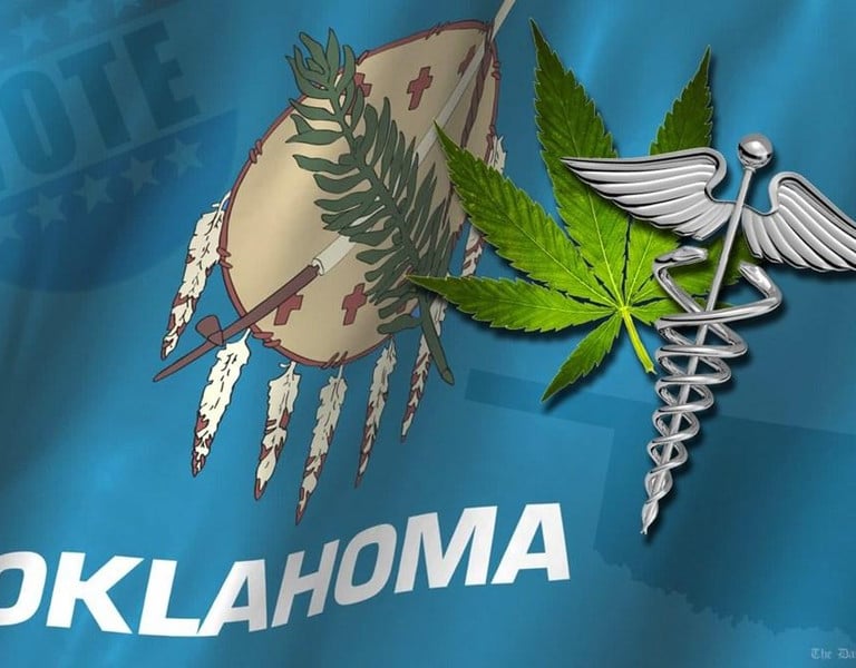 Oklahoma state flag featuring a green marijuana leaf and a silver medical caduceus symbol.