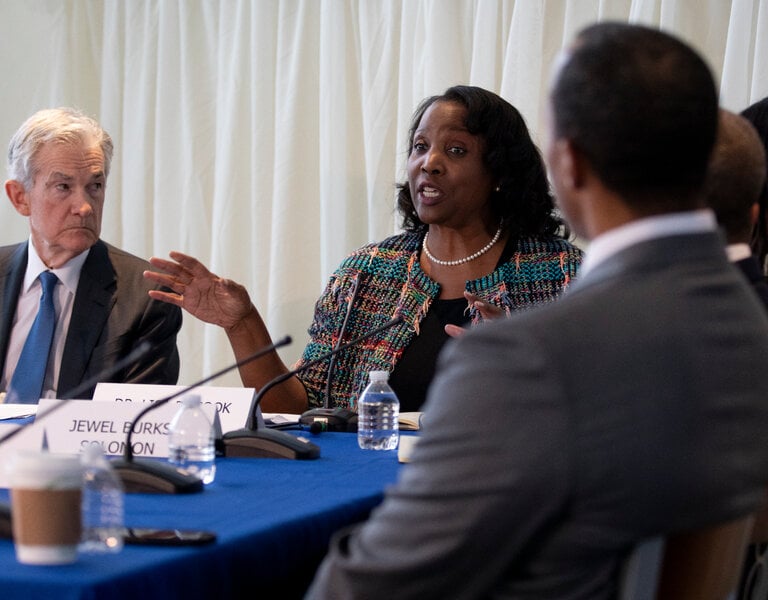 Lisa Cook speaks at a Federal Reserve roundtable discussion with Jerome Powell sitting nearby.