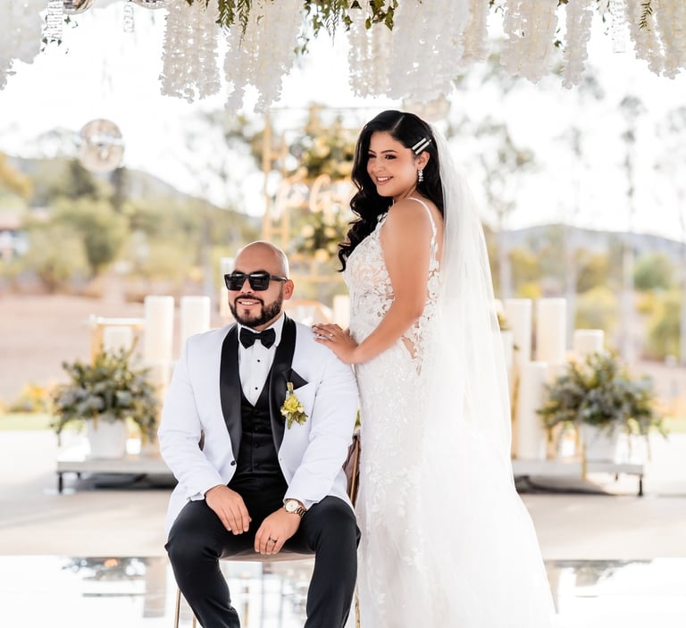 a bride and groom sitting on a chair in a wedding ceremony