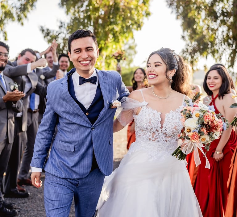 a bride and groom walking down the aisle of a wedding