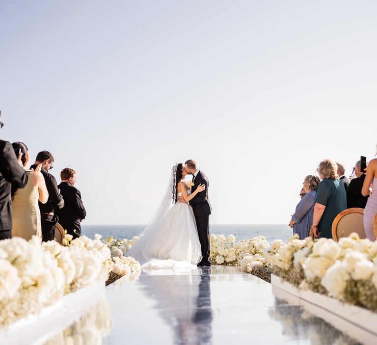 a bride and groom kissing on a wedding day
