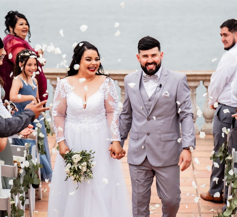 a bride and groom walking down the aisle of a wedding ceremony