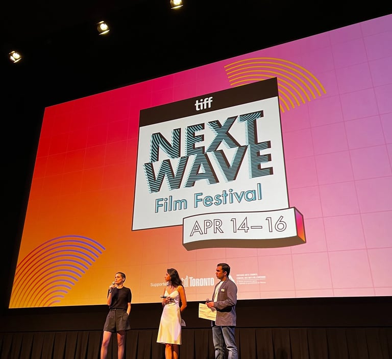 three people standing on a stage 