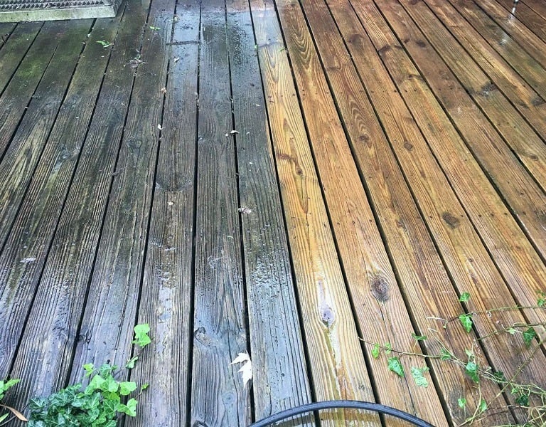A wooden deck cleaned 50/50 to show the difference