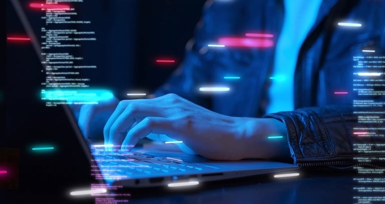 a programmer writing code on a laptop