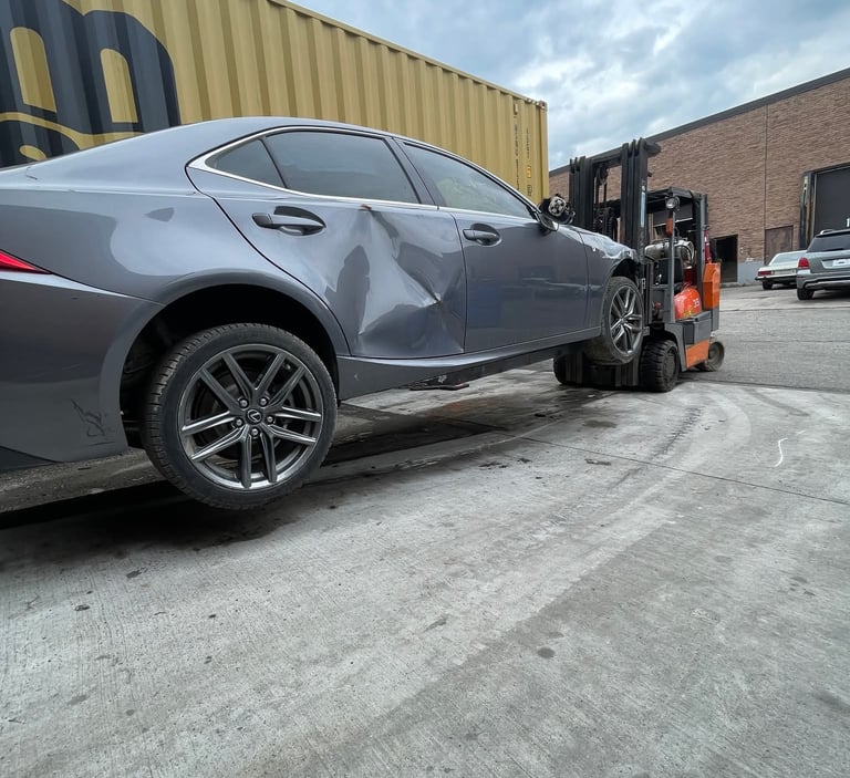 fork lift with fork extensions in use lifting a car