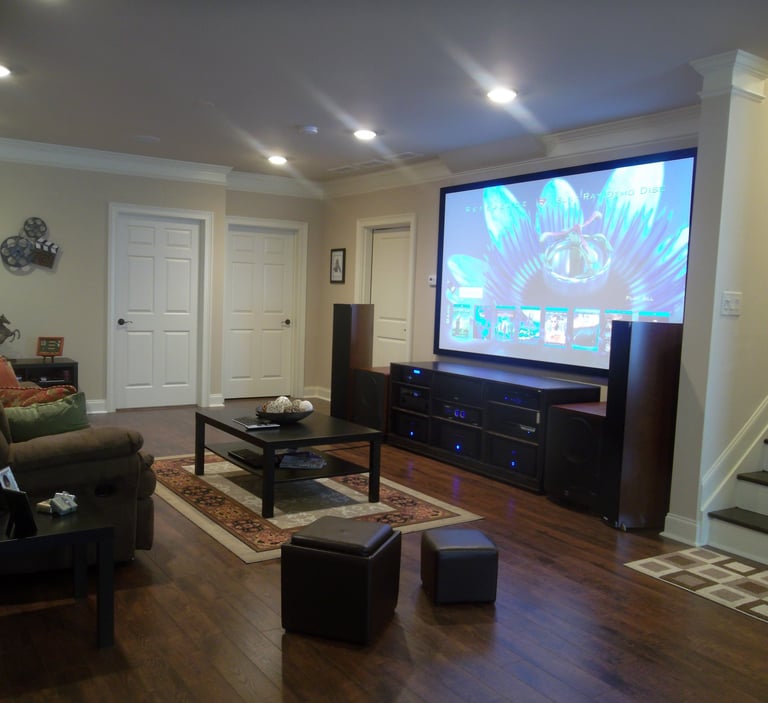 motorized projector screen installed in a luxury London living room with concealed ceiling mounting