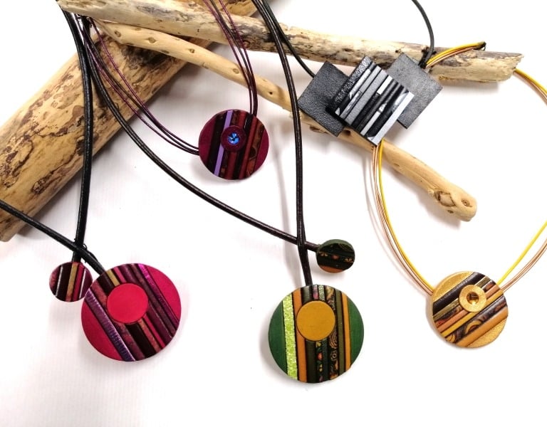 a bunch of necklaces with different colored circles