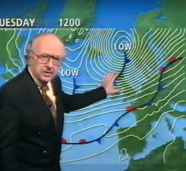 a man in a suit and tie is showinig a weather map