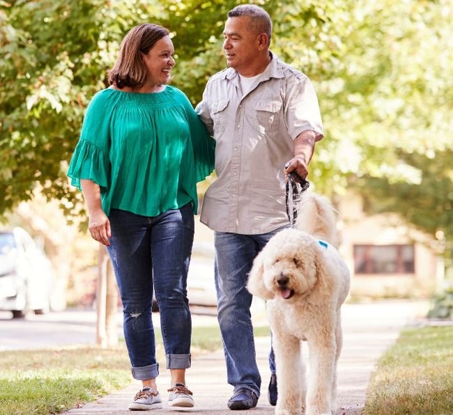 couple walking dog