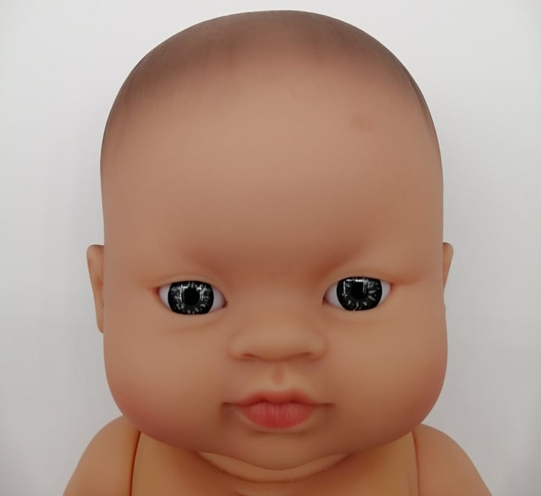 a Minikane baby doll with light coloured eyes