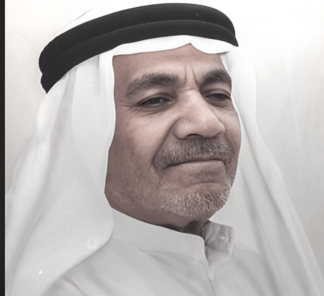 a man in a white shirt and a black and white photo