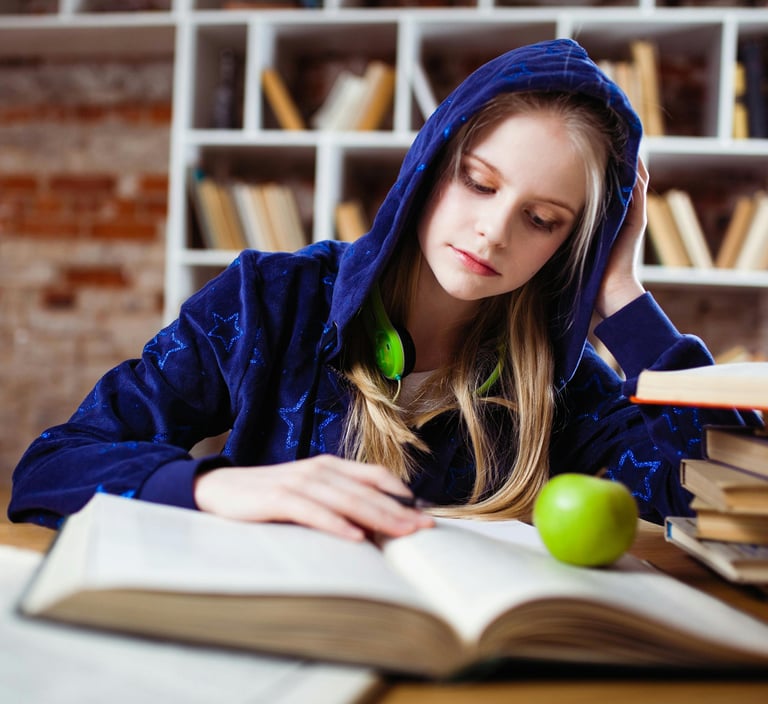 a high school student studying from a textbook