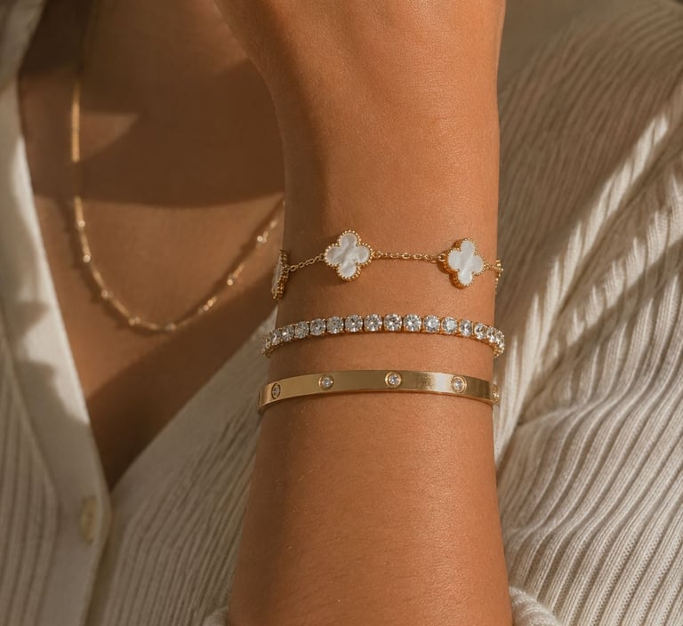 Luxury gold bracelet stack on wrist.