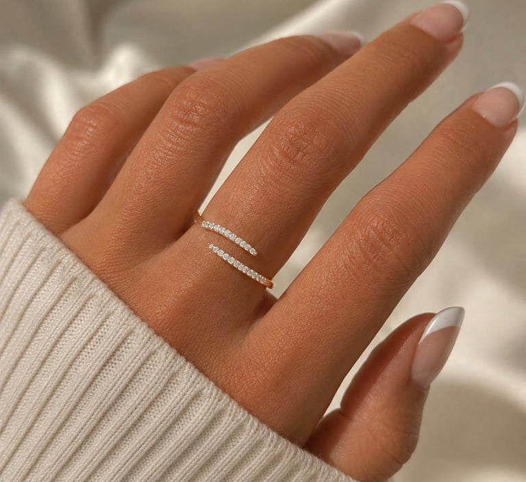 Gold crystal open ring with sparkling stones worn on a hand with a soft knit sleeve.