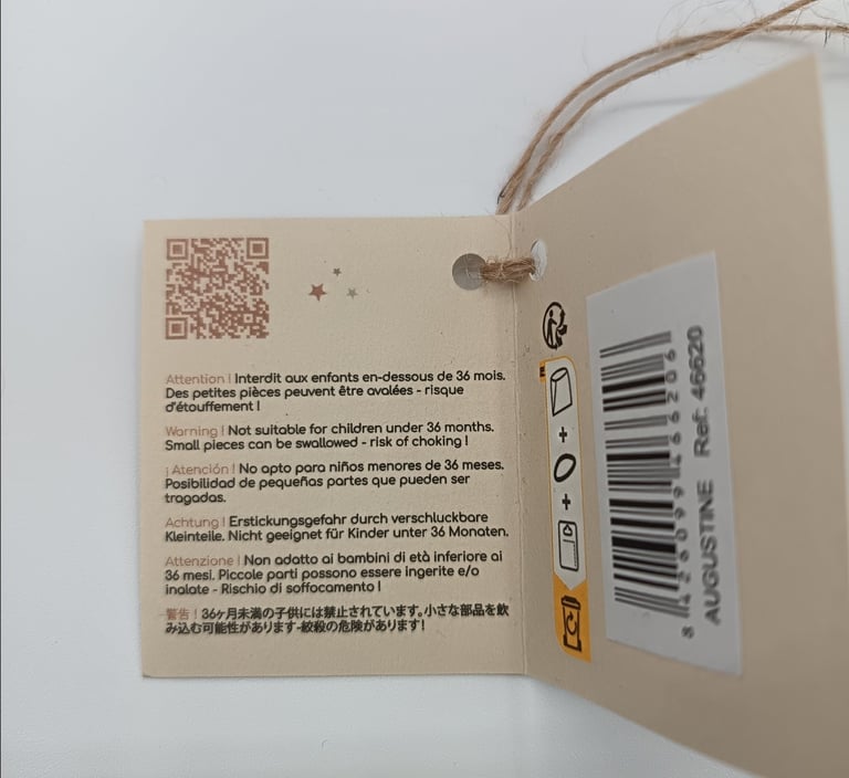 Tag with warnings for Minikane doll Augustine