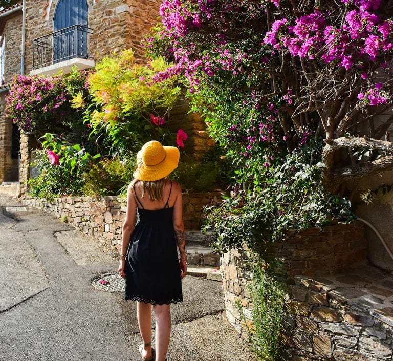 Woman Strolling Through Provence Village with Bougainvillea