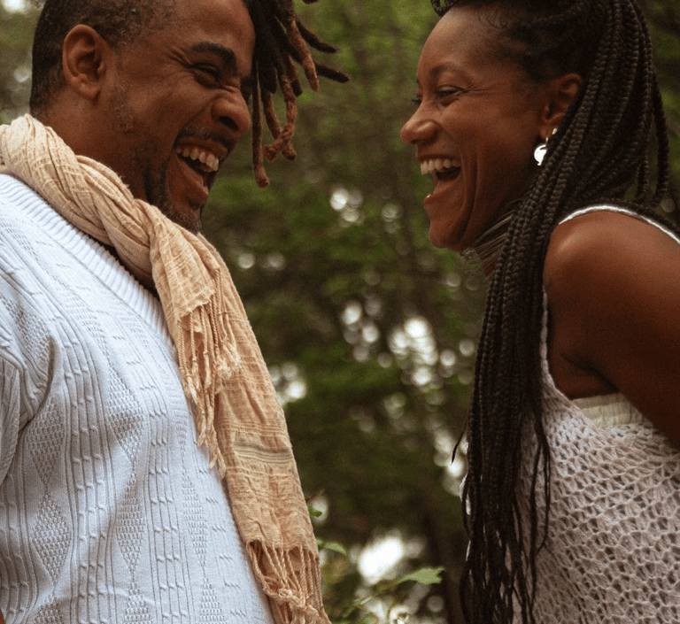 a man and woman smiling and laughing
