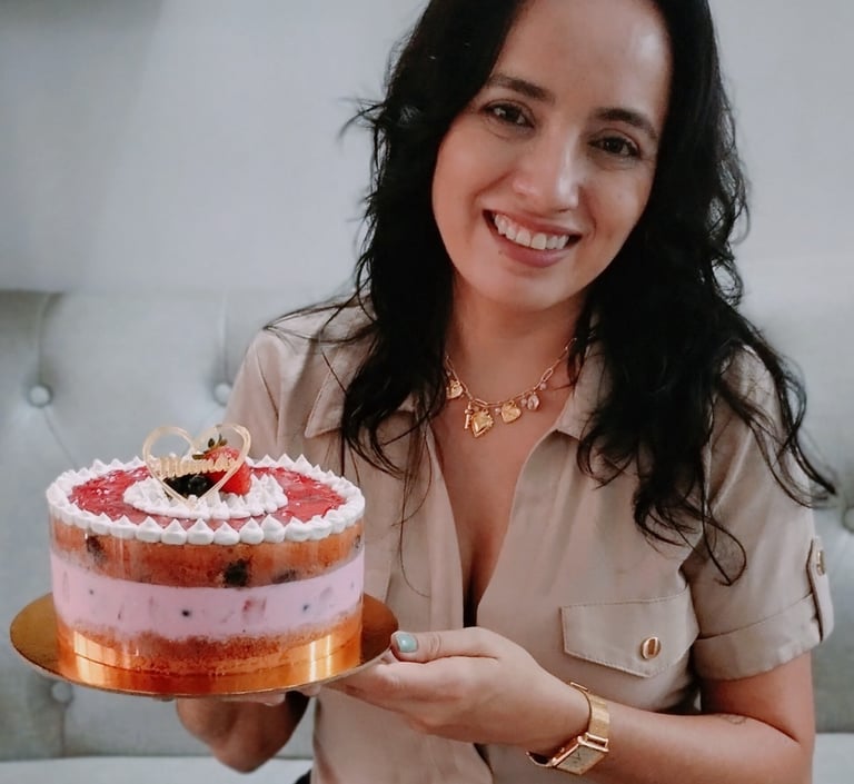 a woman holding a cake with a strawberry cream frosting