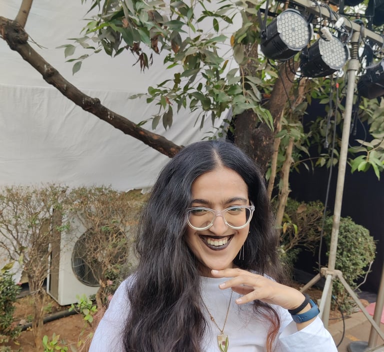 Riya, human copywriter with red streaks at the end of her hair