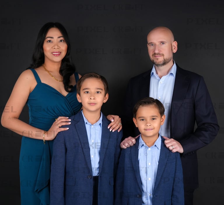 Smiling parents and kids sharing a loving moment in a beautifully lit family portrait.