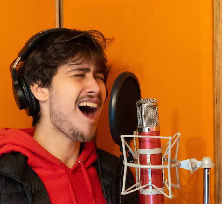 Joseph Stidworthy singing into microphone at Vox Music Recording Studio in South Manchester