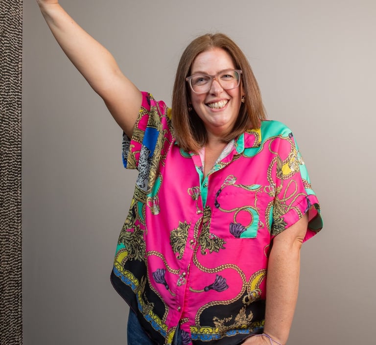 photo of gabi founder of the leopard mind smiling with arm in the air 