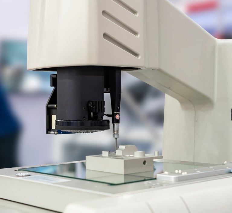 Micro-Vu optical CMM performing a CMM touch probe on a machined part.