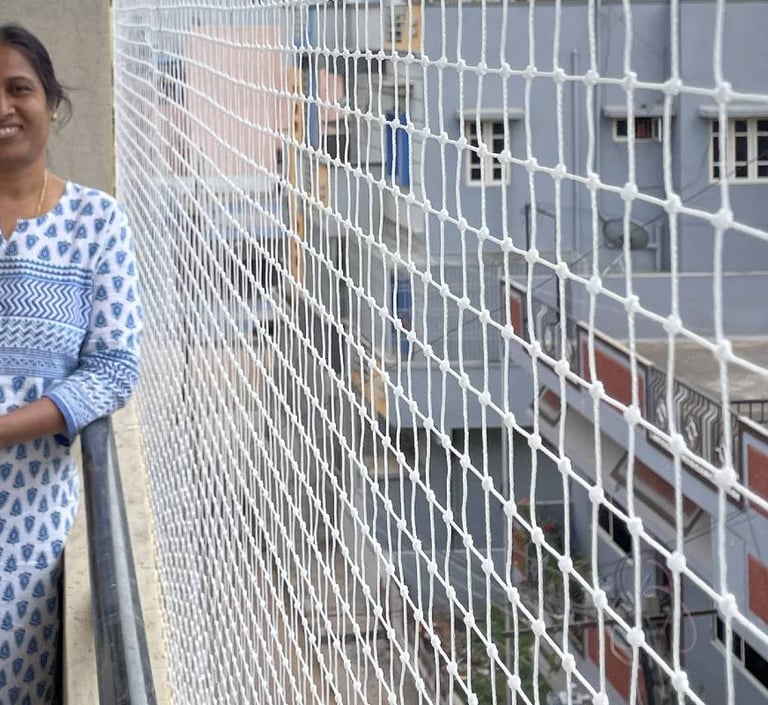 Technician carefully installing a durable pigeon net on a balcony in Thane West.