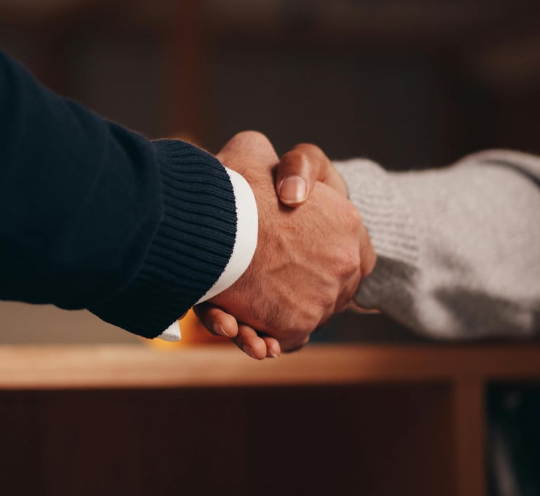 Professional close-up of a firm business handshake between two people closing a deal.