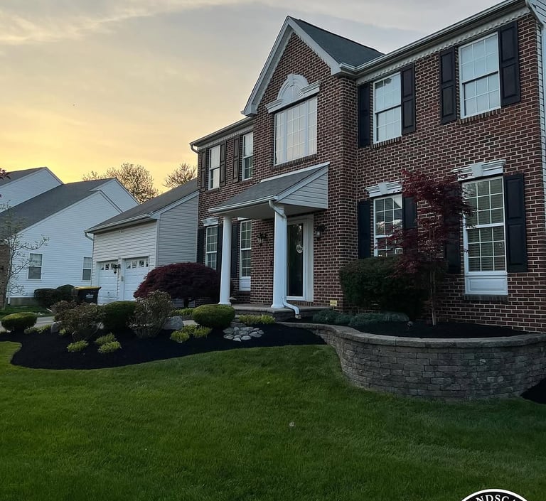 excellent landscaping and hardscaping of grass, stones and trees by NP Landscaping