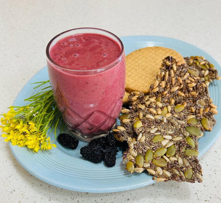 berry yoghurt drink on a plate with seed crackers
